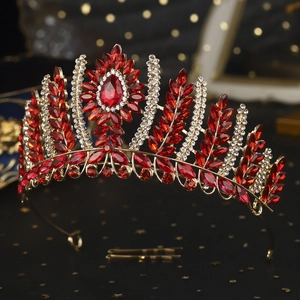 Macro detail of luxury gold crown with red marquise gems and sparkling white rhinestones