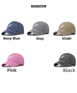 Detail showing various colors of washed cotton baseball caps with dog embroidery
