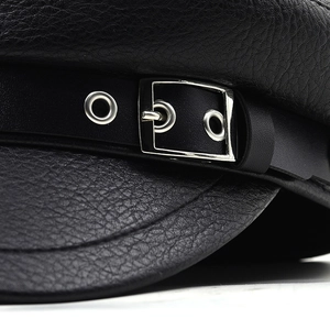 Detailed close-up of premium black PU leather grain and silver metal buckle on baker boy hat