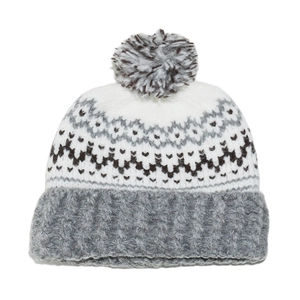 Detail of bohemian geometric jacquard knit pattern and soft grey pompom on the beanie