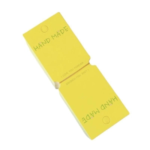 Yellow handmade paper tags with green Hand Made print for hair accessories packaging