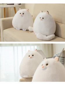Close-up of fluffy white Persian cat plush toy with soft faux fur and round egg-shaped body
