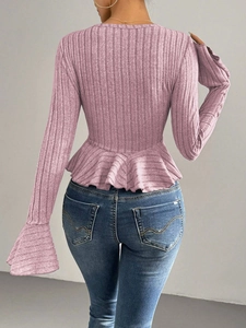 Back view of elegant pink ribbed knit top with ruffled hem and slim fit design