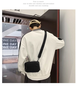 Close-up of durable black nylon crossbody bag with wide shoulder strap worn by a model