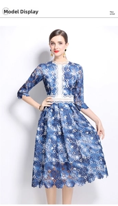 Detailed close-up of blue floral lace fabric and white crochet trim on the dress bodice