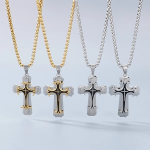 Detail view of layered titanium steel cross pendants in gold and silver with box chains