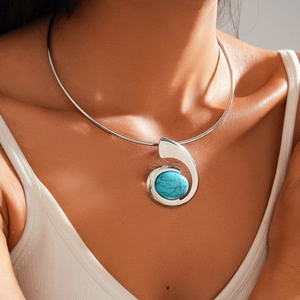 Detailed close-up of a silver twisted choker with a turquoise gemstone on a model