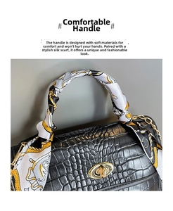 Detail of black crocodile pattern bag with silk scarf handle and gold twist lock