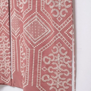 Pink bohemian cardigan with intricate white geometric embroidery and ethnic patterns