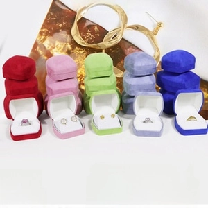 Macro view of octagonal suede jewelry boxes in vibrant colors with soft velvet lining