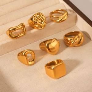 Detailed display of gold stainless steel ring set with heart and textured designs