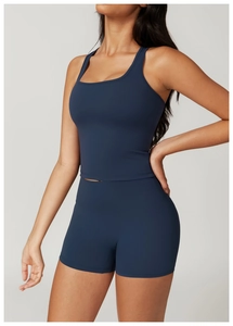 Detail view of navy blue high-waist yoga shorts and fitted sports tank top set