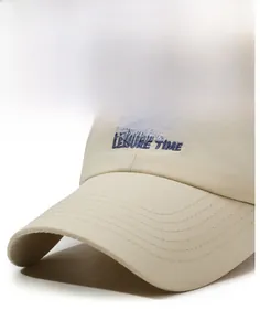 Detailed blue LEISURE TIME embroidery and reinforced stitching on a beige baseball cap