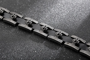 Dettaglio del bracciale gotico in acciaio inossidabile con teschi su cinturino nero
