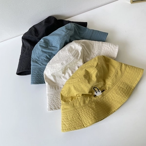 Detail of multi-color nylon bucket hats with adjustable toggles and quick-dry texture