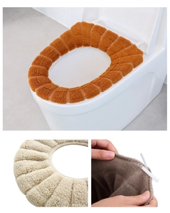 Detail of thickened pumpkin pattern knitted toilet seat covers in orange and beige