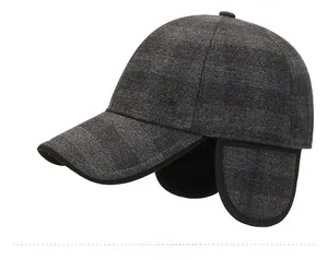 Detail view of winter ear flap baseball cap in dark gray wool blend with metal logo