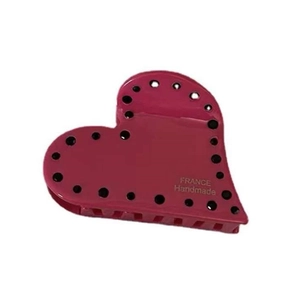 Pink heart-shaped acetate hair claw clip with black polka dots and handmade lettering