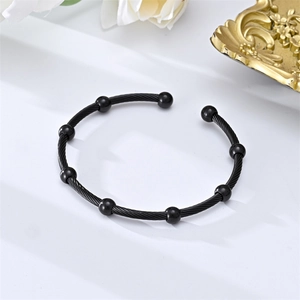 Minimalist black stainless steel cable cuff bangle featuring eight smooth round bead accents