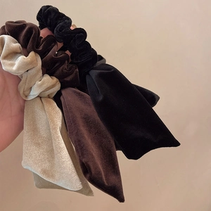 Set of velvet bow scrunchies with long ribbons in beige, dark brown, and black