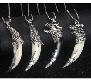 Detailed view of wolf fang pendants in silver finish with black and white acrylic accents