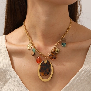 Bohemian gold chain necklace featuring leopard print pendants and retro sun motif