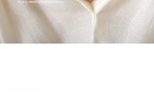 Macro detail of white ribbed knit fabric texture with V-neckline cardigan design