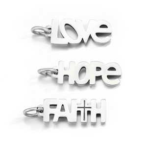 Close-up of LOVE HOPE and FAITH engraved stainless steel pendants for DIY jewelry