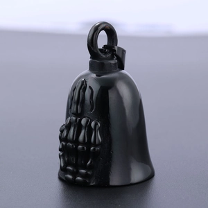 Macro view of black stainless steel motorcycle bell with gothic skeletal hand relief