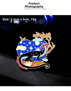 Macro shot of 5.5cm vintage dragon brooch with blue enamel inlay and golden moon details