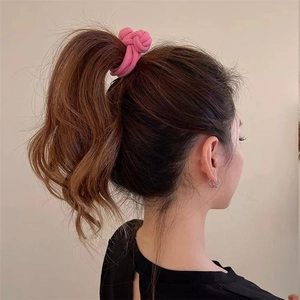Pink fabric knot hair tie shown styling a high ponytail on a model from the side