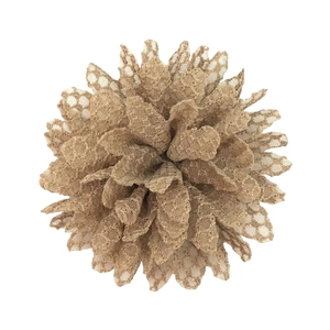 Macro detail of khaki lace flower hair accessory with honeycomb mesh texture on white background