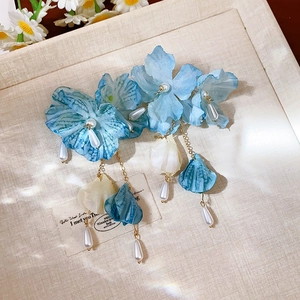 Detail of French tulle flower earrings with blue petals and hanging pearl tassels