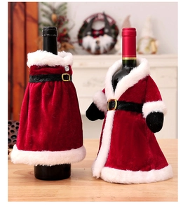Detail of red velvet Christmas wine bottle covers with faux fur trim and belt accents