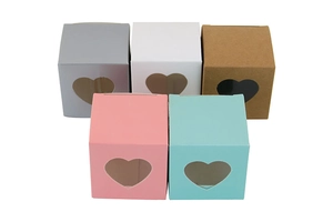 Detail view of square paper candy boxes with heart-shaped PVC window in multiple colors