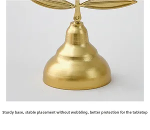 Detail of a thick gold metal base for steady placement and tabletop protection