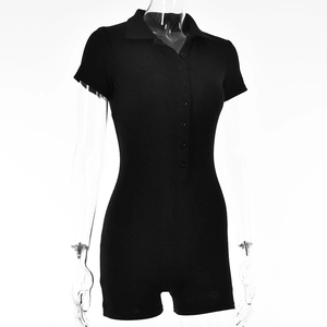 Close-up of black polo-style romper featuring short sleeves and front button closure detail