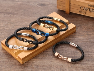 Detail view of woven leather bracelets with infinity symbols in five metallic colors