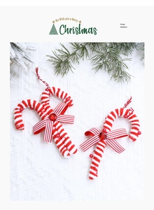 Detail of red and white striped foam candy canes with bows on white knit background