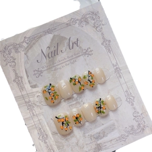 Hand-painted press-on nails with 3D persimmon fruit designs and watercolor leaf patterns