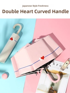 Pink heart print sun umbrella with matching storage sleeve and curved J-hook handle