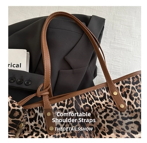 Close-up of leopard print tote bag with brown leather straps and metal rivet details