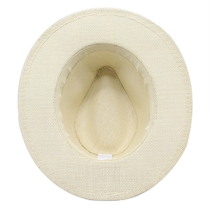 Detail view of woven straw hat interior featuring 100% paper fiber texture and care label