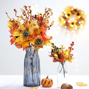 Autumn harvest faux flower arrangement with pumpkins, maple leaves, and berries in glass vases