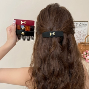 Vintage acrylic geometric hair comb with gold H logo in tortoise and black colors