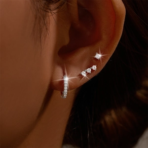 Close-up of S925 silver earring set with white zircon and sparkling stud details