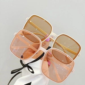 Fashionable oversized square sunglasses with amber frames and pink lenses for women