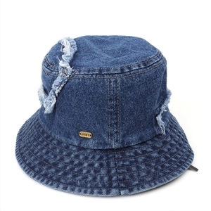 Close-up of distressed denim bucket hat with frayed edges and metallic logo plaque