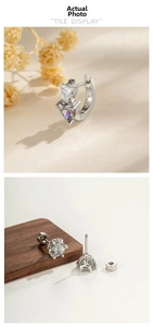 Detailed view of silver heart zircon ear hoops and classic six-claw stud earrings