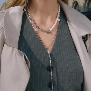 Detail of layered freshwater pearl necklace with silver OT buckle on a fashion model